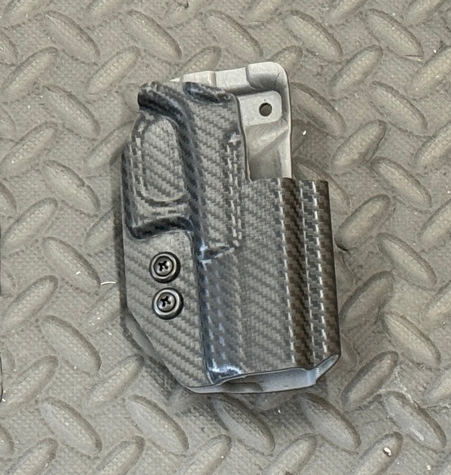 A black dual layer OWB holster for Glock 19/23 pistols, displayed on a textured background.