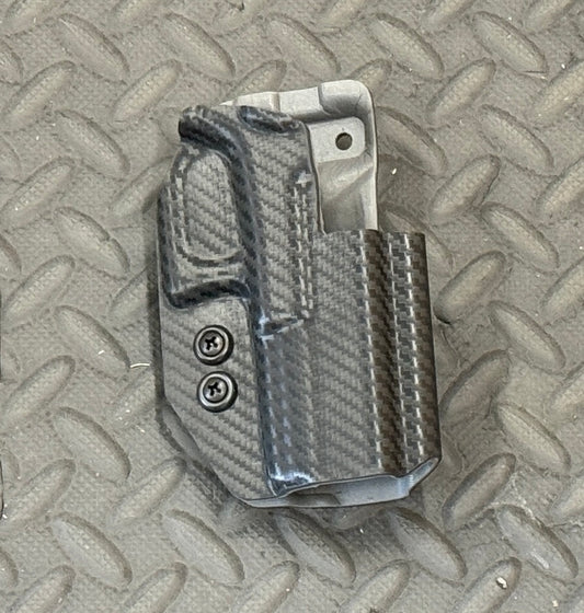 A black dual layer OWB holster for Glock 19/23 pistols, displayed on a textured background.